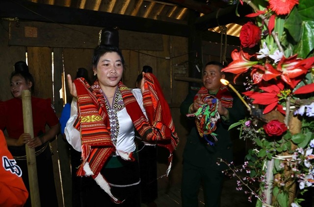 A Xinh Mun woman performs the xòe dance during Sà Típ Festival